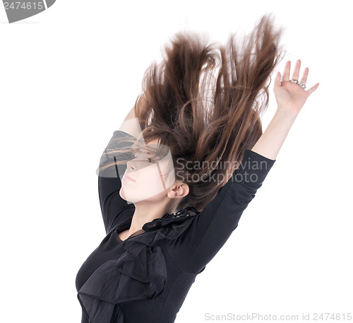 Image of Young woman with her hair flying in the air
