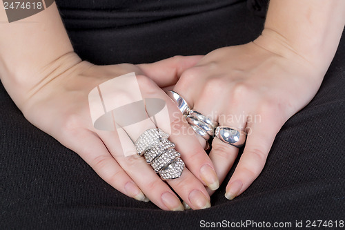 Image of Woman wearing multiple rings