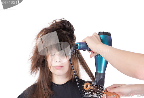Image of Woman enjoying having her hair blow dried