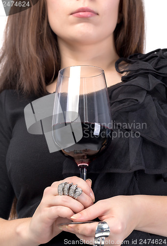 Image of Young woman with red wine from a glass