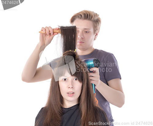 Image of Woman enjoying having her hair blow dried
