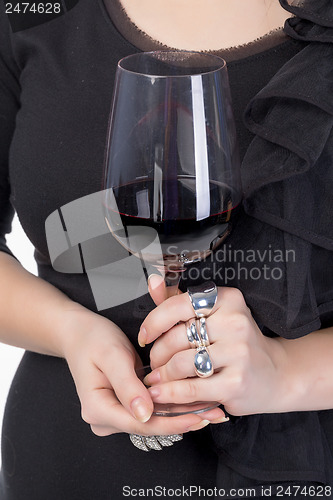 Image of Young woman with red wine from a glass