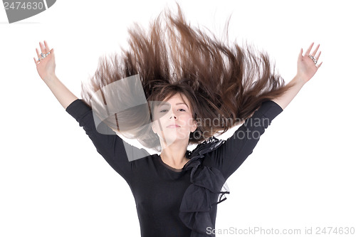 Image of Young woman with her hair flying in the air