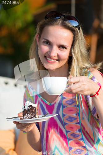 Image of girl with a cup of coffee and cake