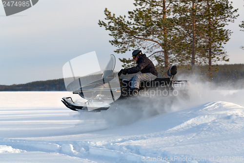 Image of man riding a snowmobile