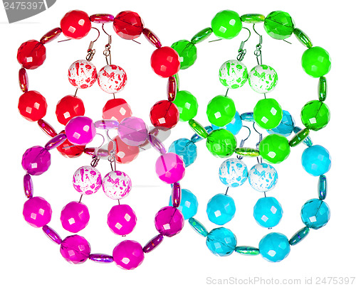 Image of Earrings and bracelets made of plastic and glass on a white back