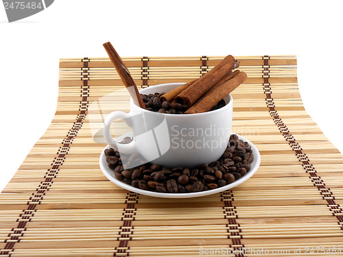 Image of Coffee beans with coffee cup, cinnamon on bamboo background