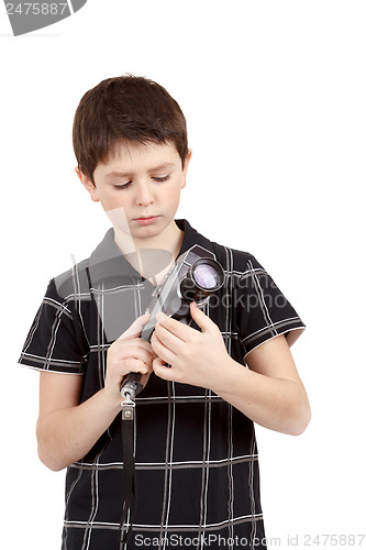 Image of young boy with old vintage analog 8mm camera