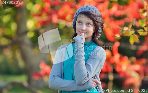 Image of girl thinking in nature on background of autumn