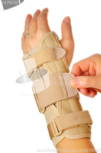 Image of female wearing wrist brace over white background