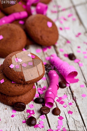 Image of chocolate cookies, coffee beans, pink ribbons and confetti