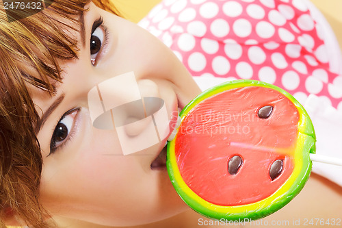 Image of attractive girl with a round lollipop