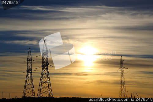 Image of electric masts at sunset