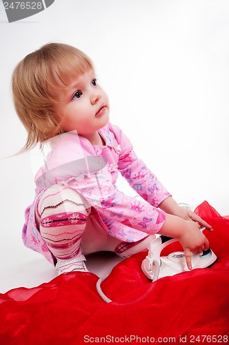 Image of little, blond hair girl ironing