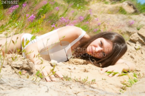 Image of elegant nude woman climbing on sand