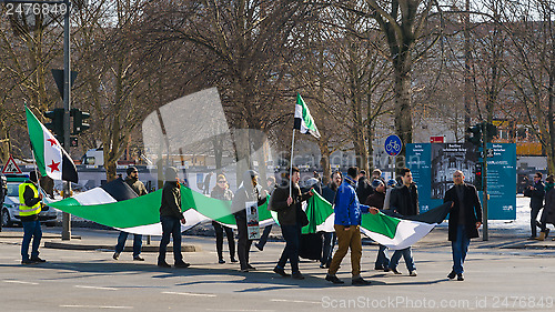 Image of Pro-opposition activists carrying the Syrian flag on demonstrati