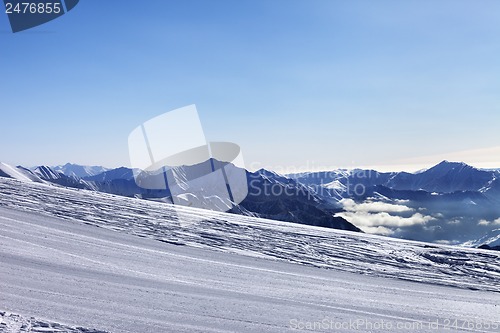 Image of Ski slope and snowy mountain in haze