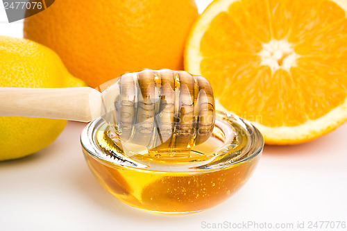 Image of fresh honey with lemon and orange fruits