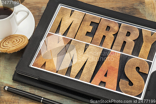 Image of Merry Xmas on digital tablet