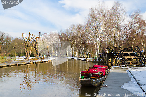 Image of Boat near the pier on springtime canal