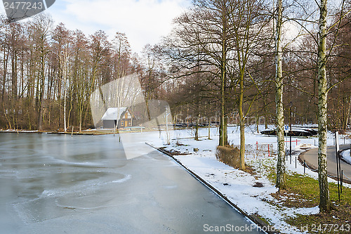 Image of Springtime european park with frozen channel