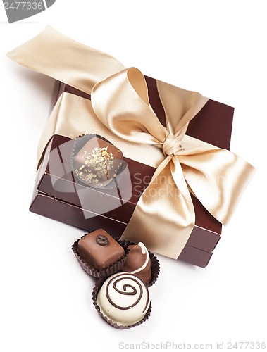 Image of brown box with candies and golden tape