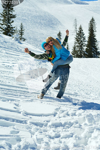 Image of Young Couple In Winter  Snow Scene