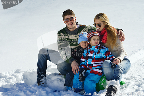 Image of family having fun on fresh snow at winter