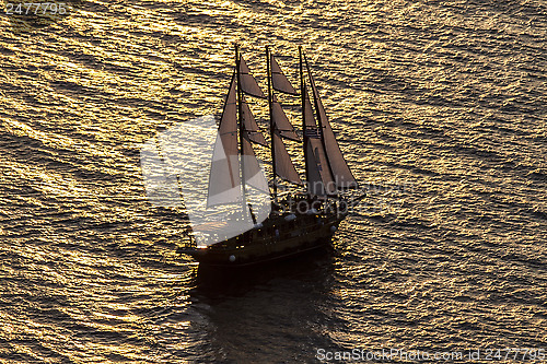 Image of Sailing boat and sunset in Santorini, Creece