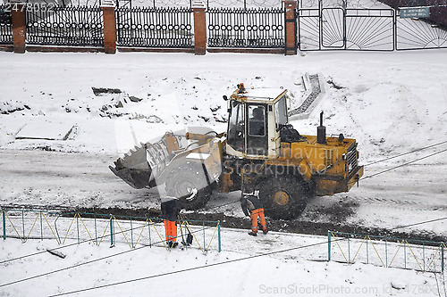 Image of Special equipment on road construction. Snowfall.