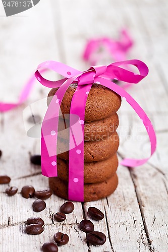Image of stack of chocolate cookies tied with pink ribbon and coffee bean