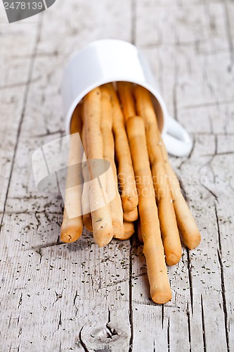 Image of cup with bread sticks grissini