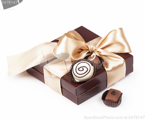 Image of brown box with candies and golden tape