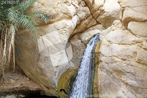 Image of A waterfall flows from the mountain