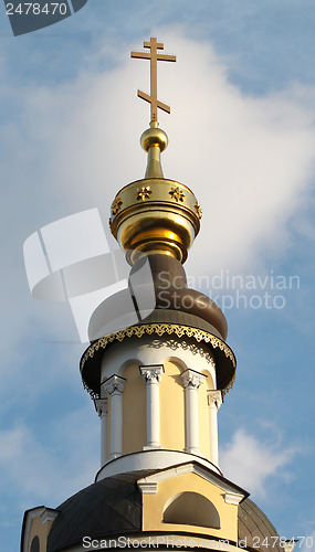 Image of The golden dome of the church with the cross
