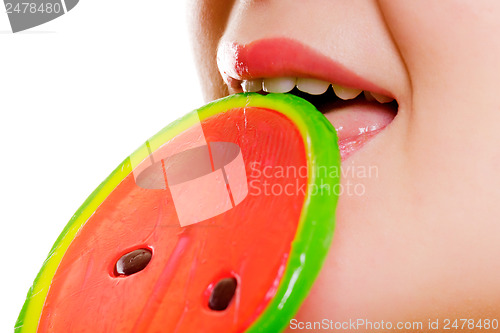 Image of Female mouth with a round lollipop