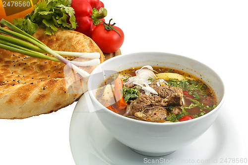 Image of Kharcho soup with bread and vegetables