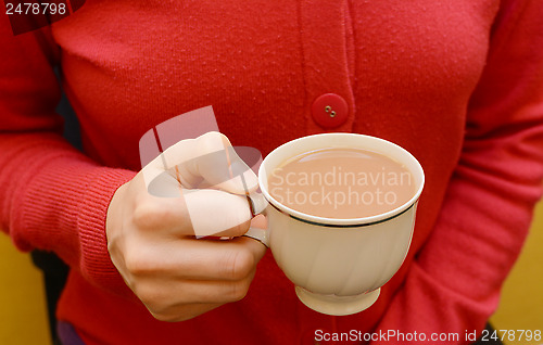 Image of Cup of tea in a woman's hand