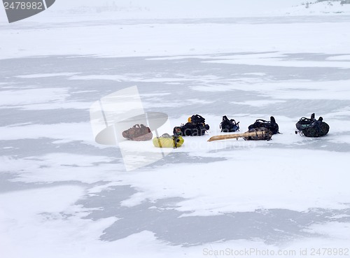 Image of tourist backpacks in the winter on ice