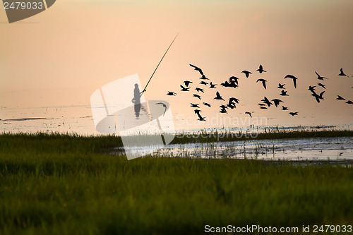 Image of Fisherman silhouette on the lake