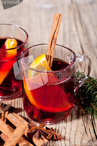 Image of hot tasty spicy mulled red wine with orange and cinnamon christmas 