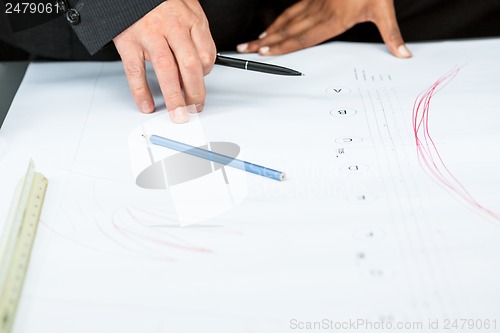 Image of business people discussing architecture plan sketch 