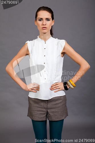 Image of young attractive brunette woman in studio portrait