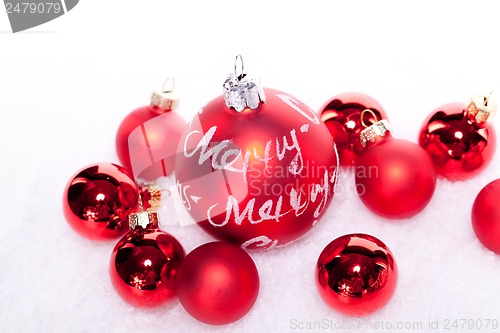 Image of christmas decoration festive red bauble in snow isolated