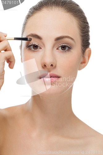 Image of doing the makeup brown eyeshadow on beautiful eyes