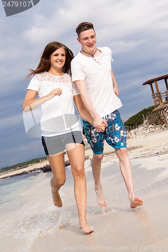 Image of happy young couple on the beach in summer holiday love