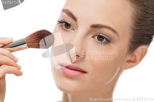 Image of apllying powder make up on face portrait