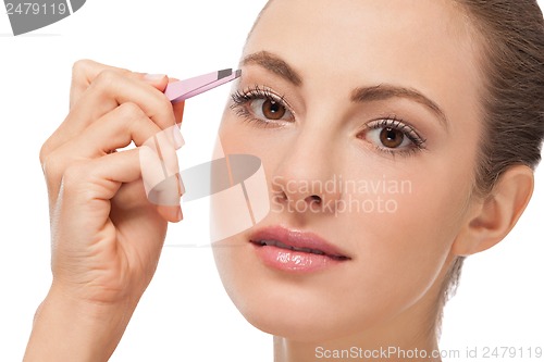 Image of youtg beautiful woman eyebrow plucking tweezers eyes hair 