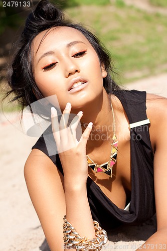 Image of beautiful asian woman with colorful makeup on the beach 