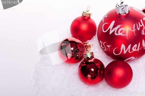 Image of christmas decoration festive red bauble in snow isolated